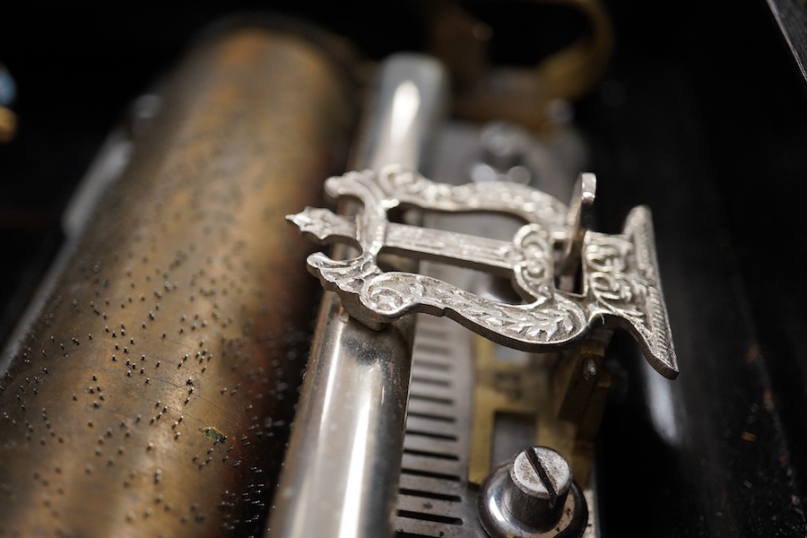 A 19th century Swiss cylinder music box, in a walnut and kingwood cross banded case, with 43 tooth cylinder (missing one tooth), and three bells with butterfly hammers, playing eight airs, cylinder 15.5cm long, case 48cm